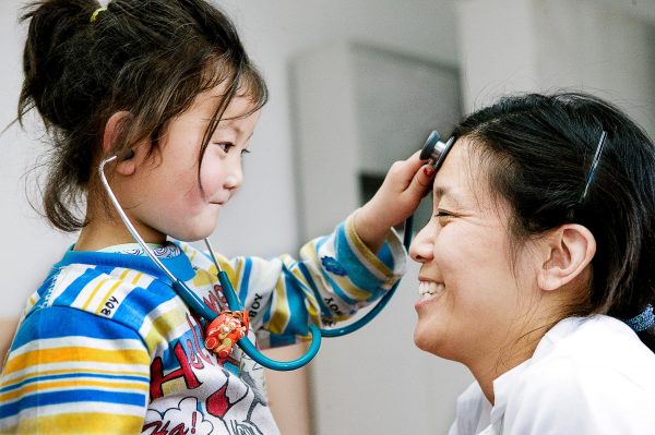 Child and Doctor playing with stethoscope