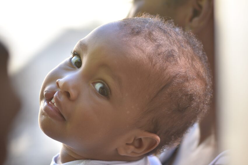 Young boy turns his head to look at the camera