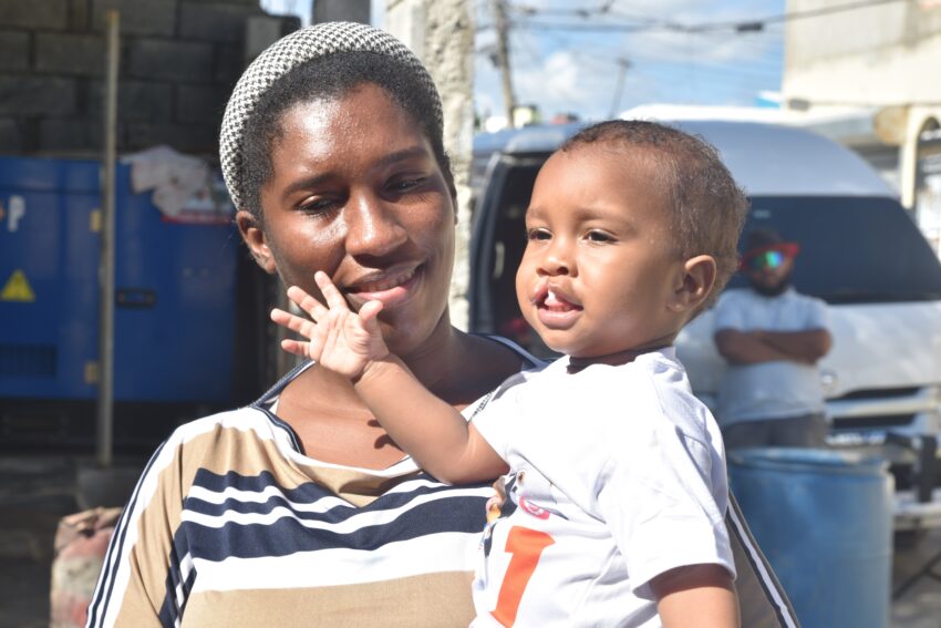 Mother and young son standing in the street