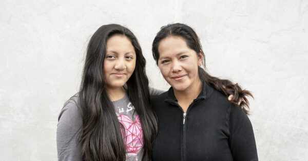 Girl stands with her mother