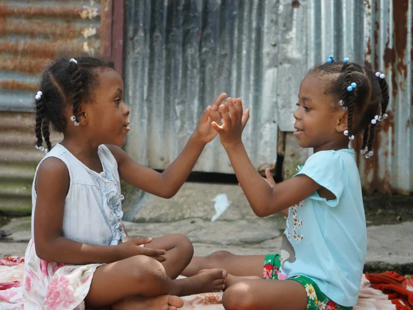 Daniela, age 4, from Dominican Republic, playing games with her sister