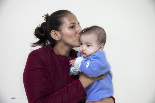 Mother holds her child close