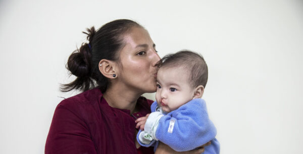 Mother holds her child close