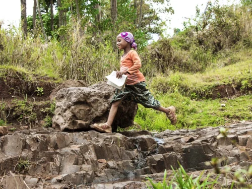 Nazifa from Ethiopia runs across the countryside to get to school.