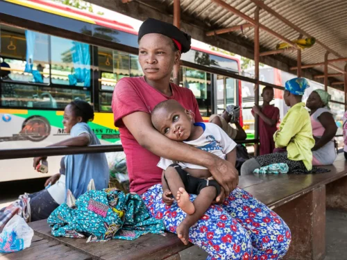 Mother Awulatu and baby Ismael at Tema bus station in central Accra. The family live at the bus station and sleep in a make shift bed underneath the waiting area benches.