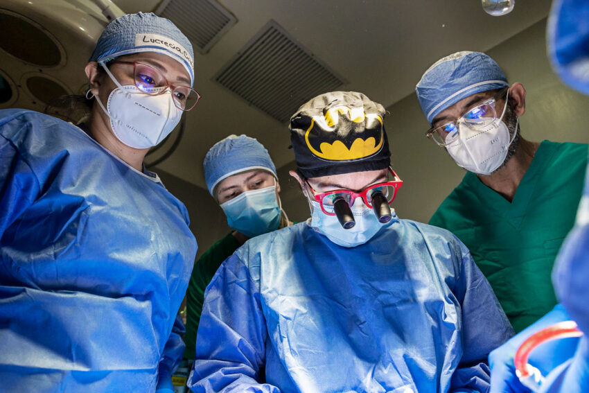 A group of people wearing surgical masks and scrubs