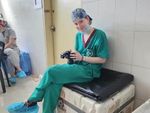 Photography Imaging Technician (PIT), Kate Fischer, reviews the photos she's taken in the OR during a surgical program in Bolivia.