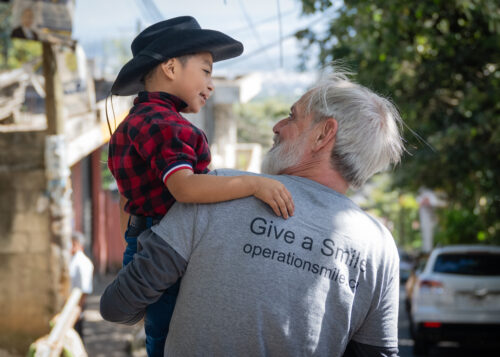 Man holding child wearing a cowboy hat