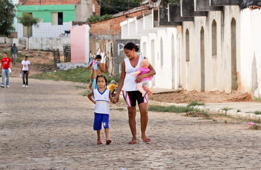 Maria Eulália Cabralda Costa, walking to school with her grandmother