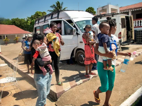 Patients get off a van at the patient shelter during Operation Smile's medical mission in Majunga, Madagascar