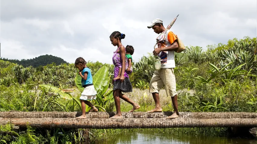 Vaviroa Lalatianan, 6 years old. Bilateral Cleft lip, Before, Youngest Daughter: Arimalala Nambina, 2 years old, Unilateral Cleft lip, Before. Father: Dest Velontsoa Mother: Rosoa Arimalala Aunorine Photo Shows: Walking from home to their nearest hospital at Anivorano Est where they can find informations about Operation Smile and find transport to take them to the mission in Tamatave. The walk takes 3 hours over rough terrain and rivers.