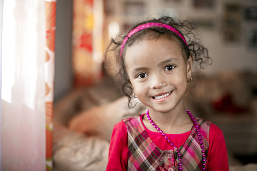 Young girl smiles at the camera