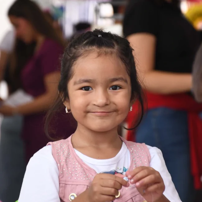 Lilia creates beaded jewelry while waiting for her speech therapy consultation.