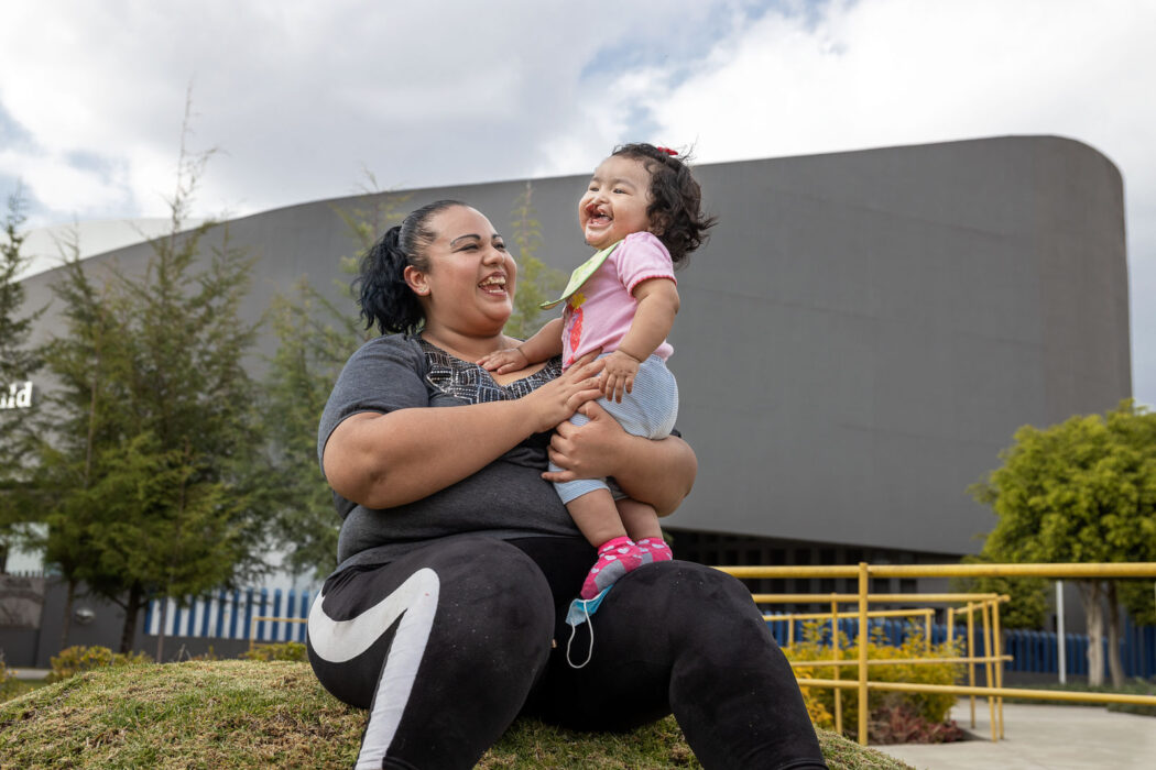 Valeria holding a smiling Lilia