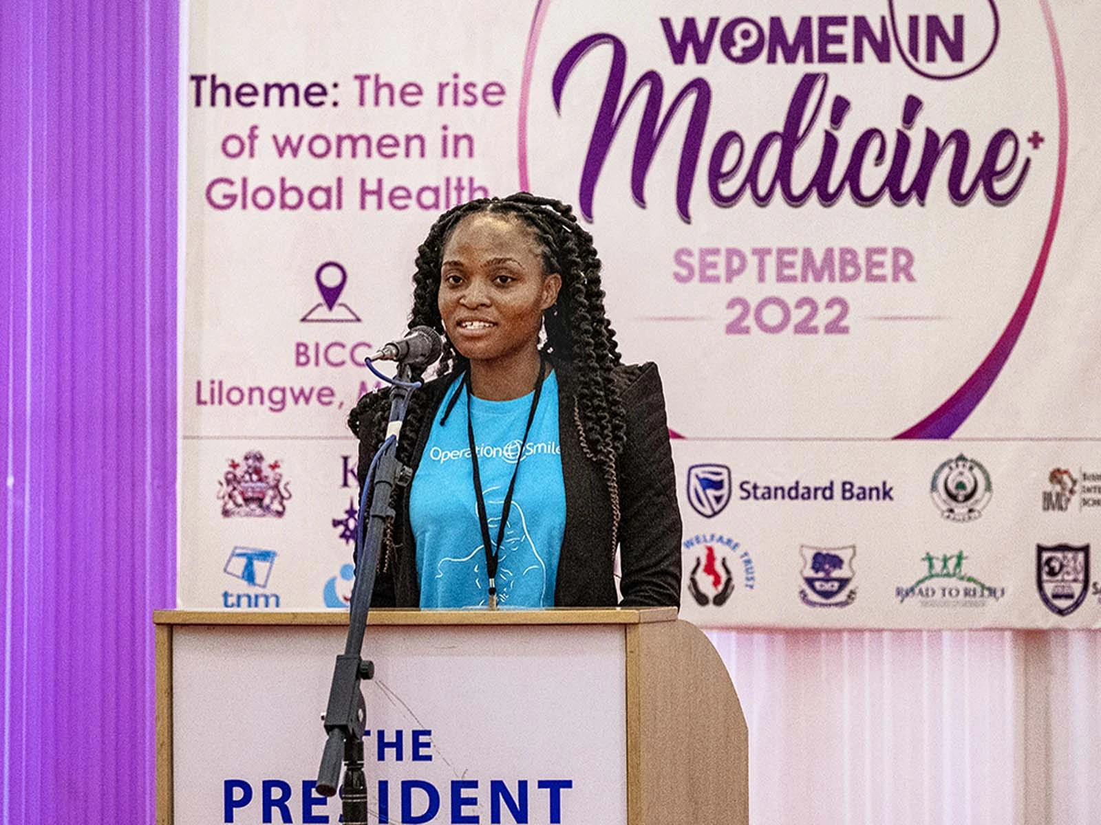 Carol, former patient turned volunteer, speaking during a Women in Medicine program in 2022