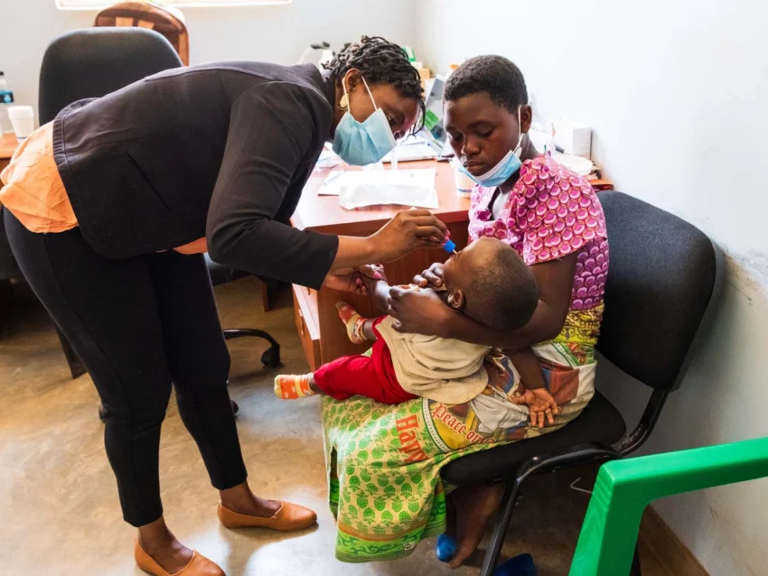 A medical volunteer collects a DNA sample from a patient in Malawi.