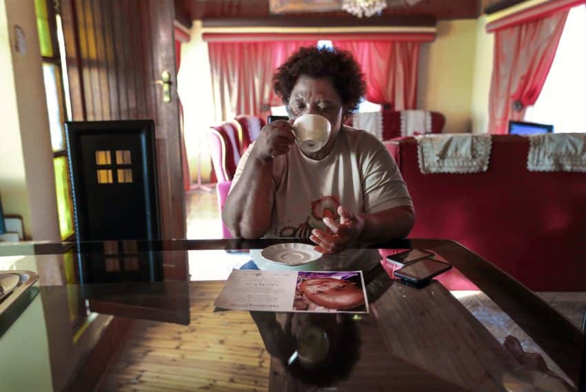 Nurse Funeka Cele sipping tea at her home