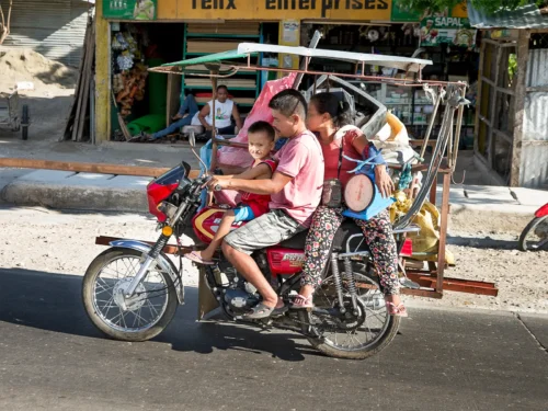 Joseph Misa, 6 years old riding on a motorcycle with his parents