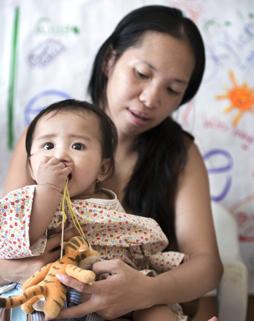 Mother holding infant child on her lap