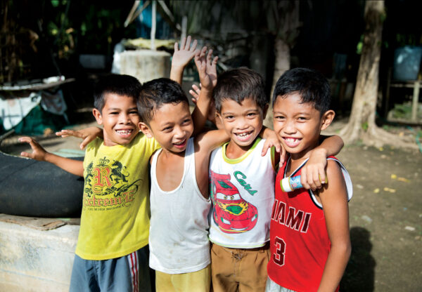 Four boys from Cebu, Philippines, smiling